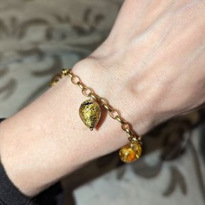 14k gold chain bracelet with 4 gold dipped glass heart charms. Kay Jewelers